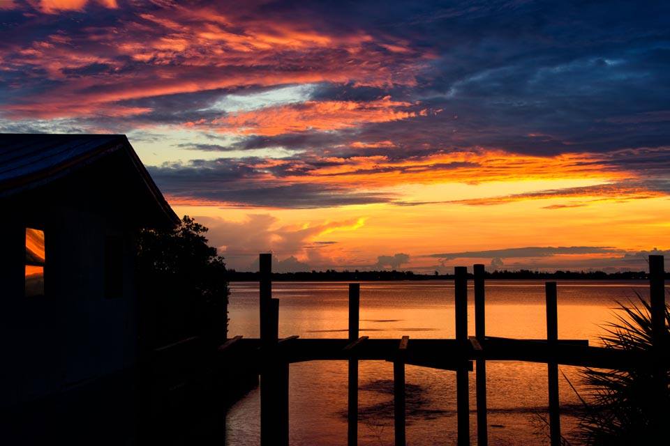 sunset by a waterfront house